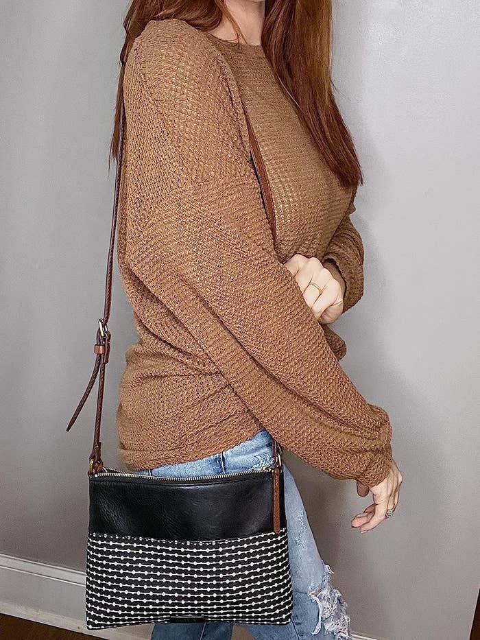 reviewer wearing the brown with white striped lower pattern bag over shoulder