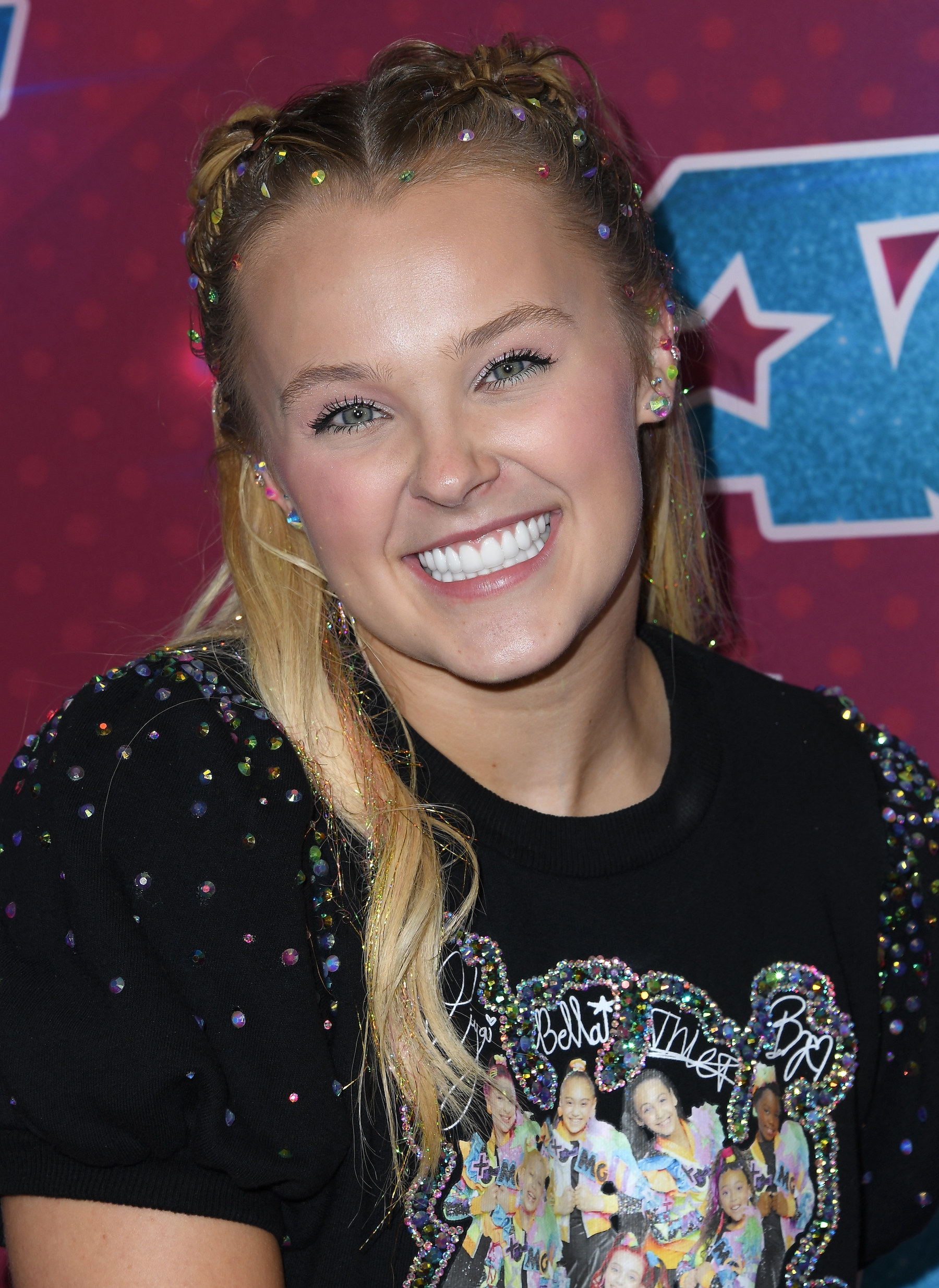 Close-up of JoJo smiling and wearing a bejeweled T-shirt