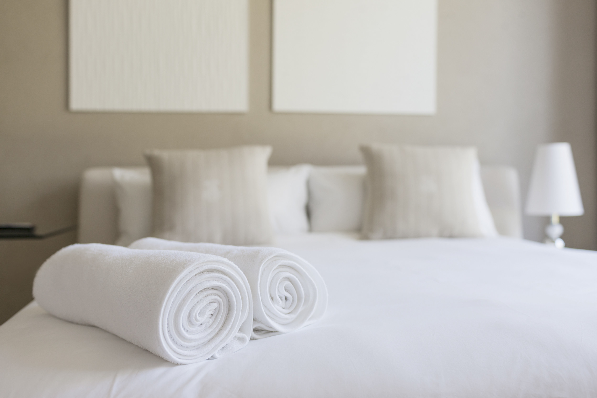 A white bed with fresh towels