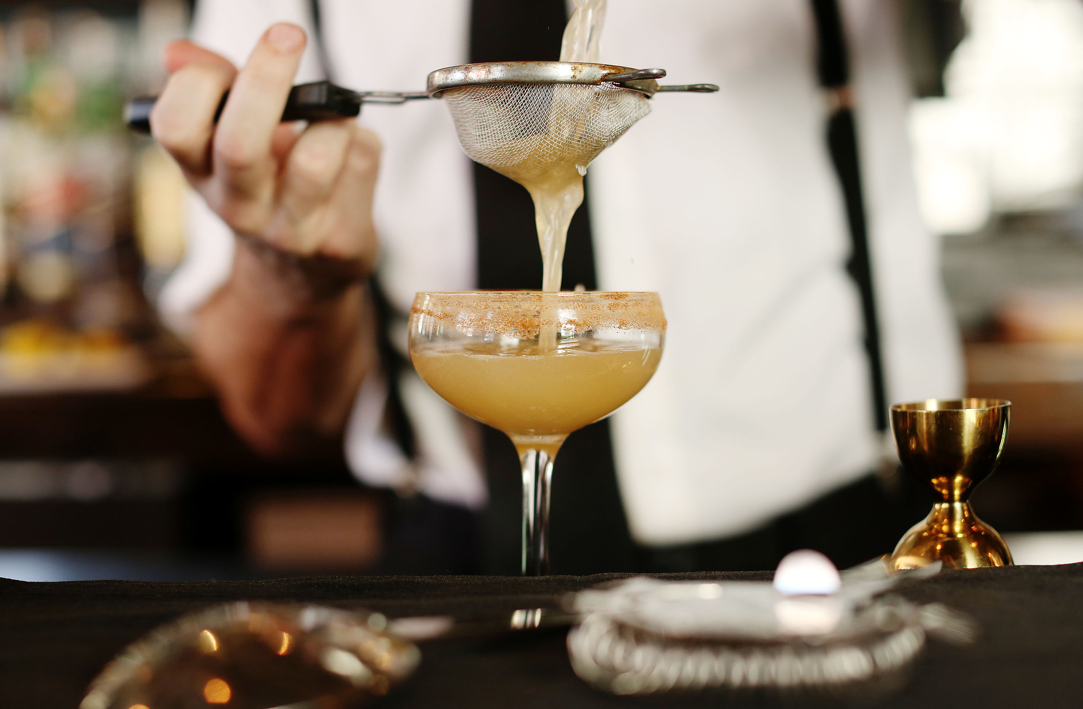 A bartender making a cocktail.