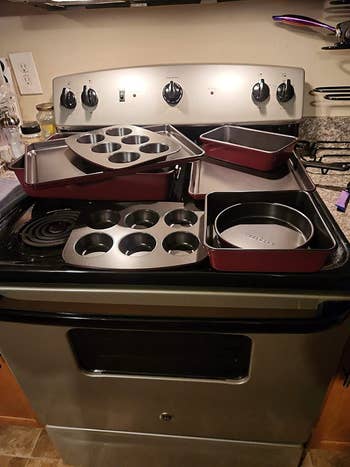 All the pans from the bakeware set on reviewer's stove