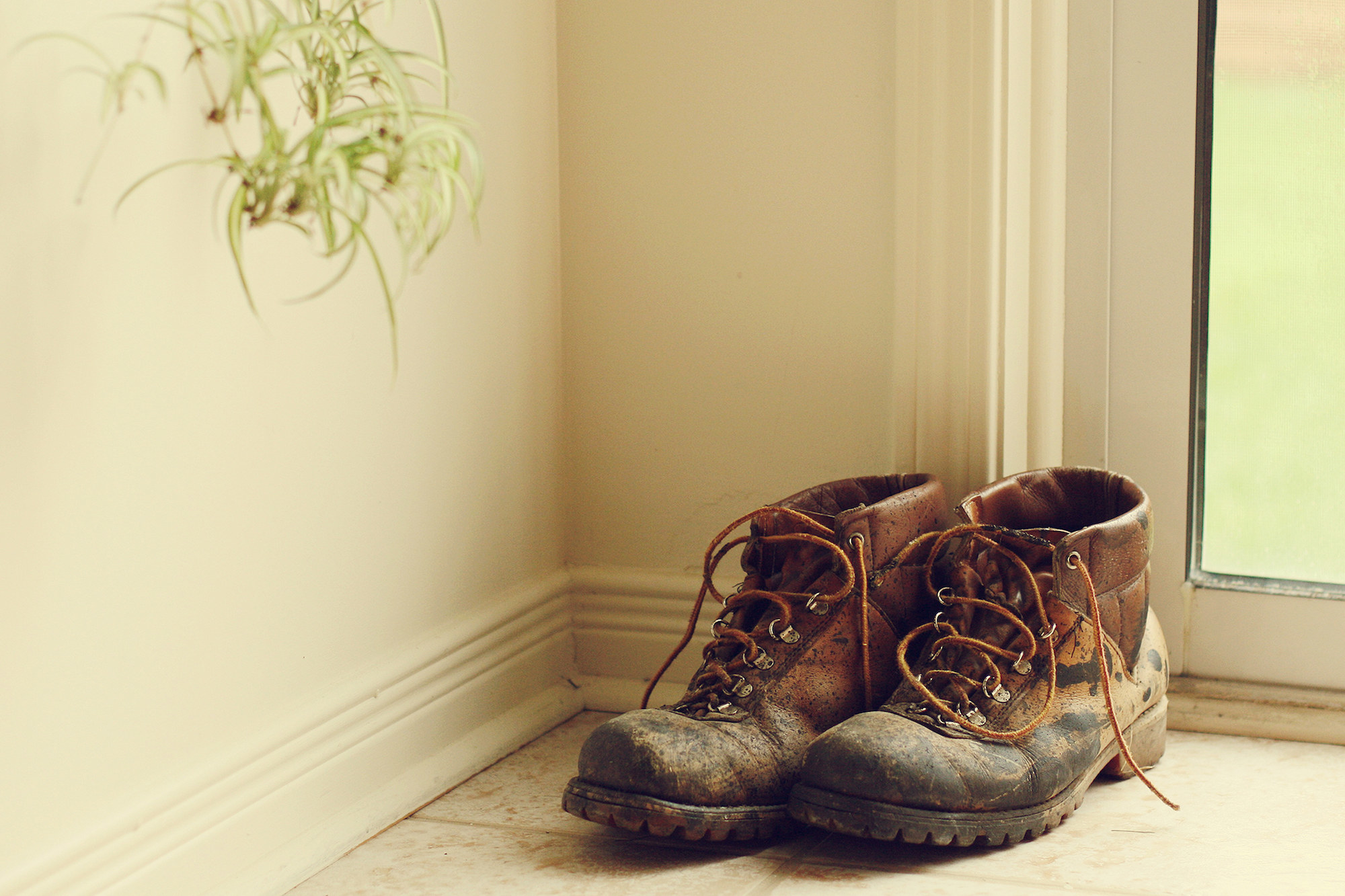 A pair of work boots by a door