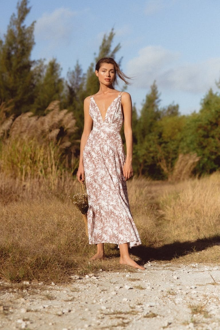 model in brown and white maxi dress