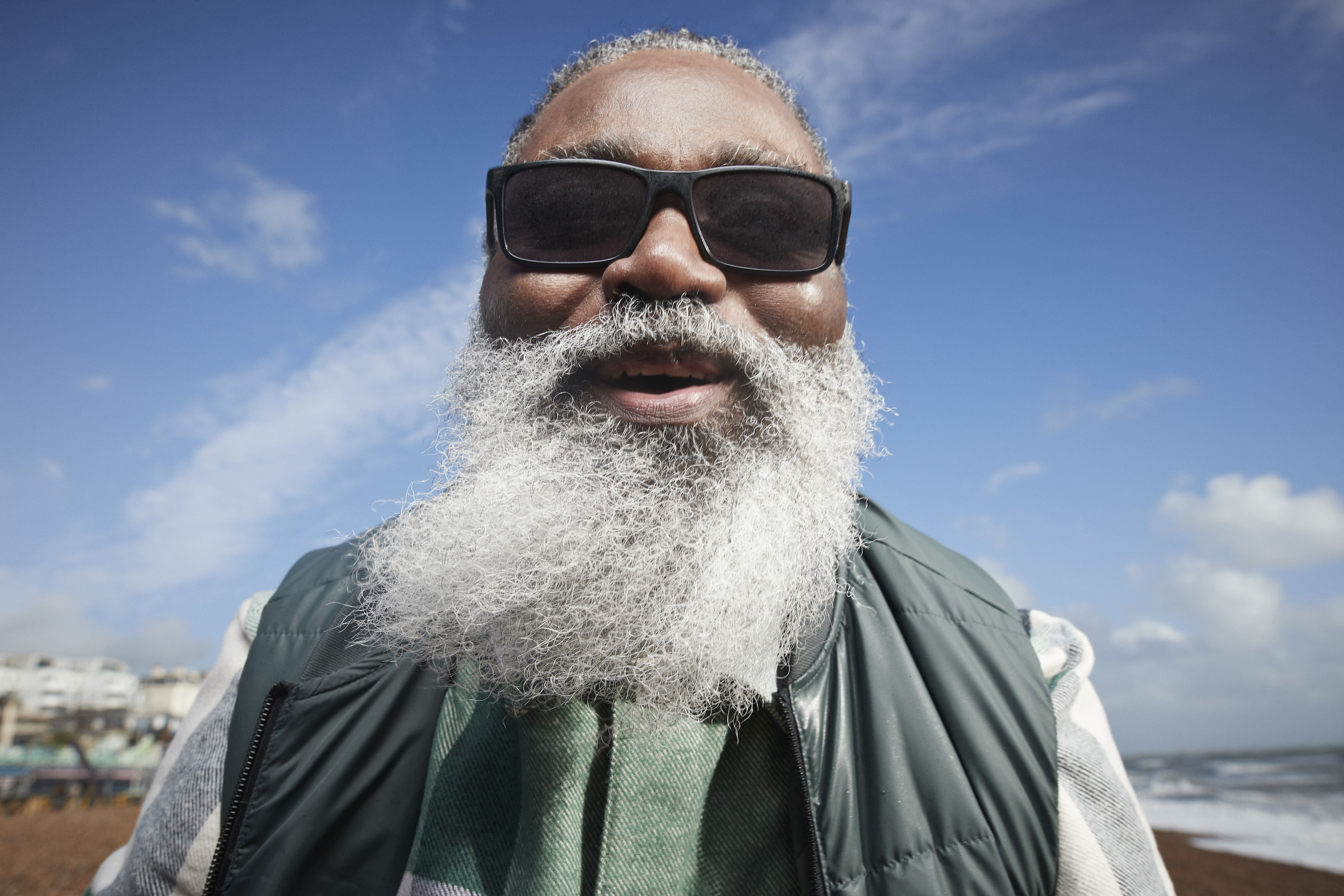 Closeup of a man with a long beard and wearing sunglasses