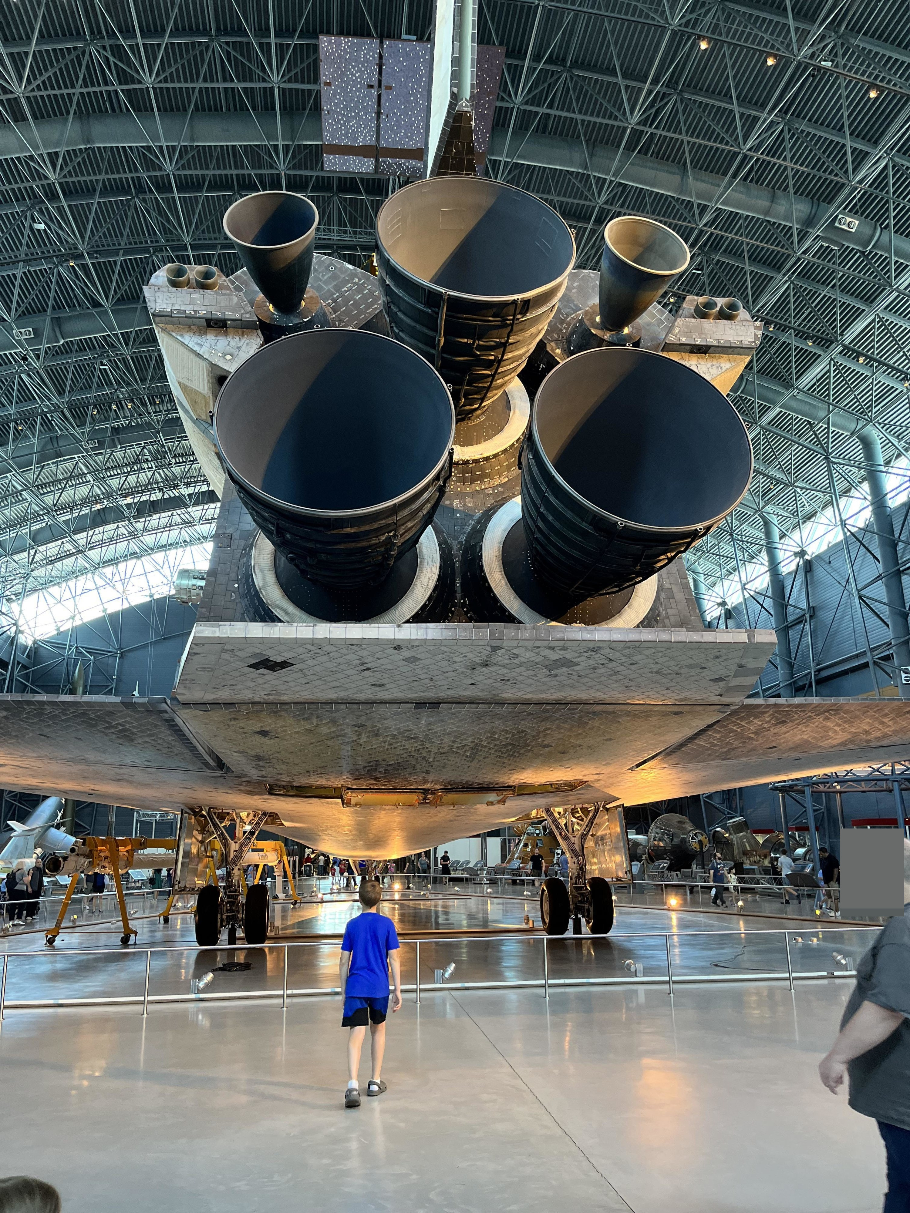 A little boy looking at the Space Shuttle Discovery engines