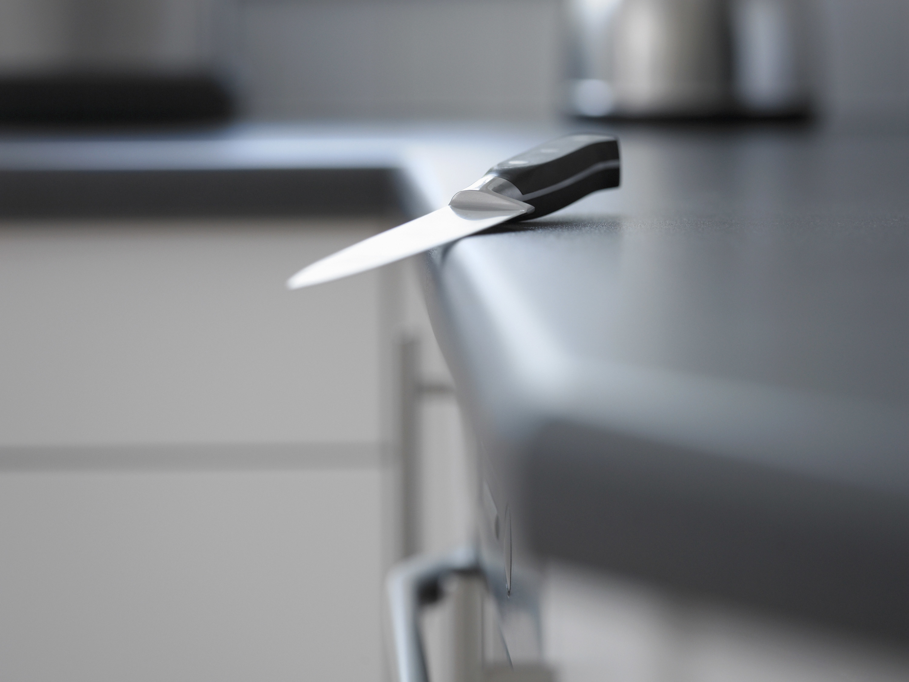 a knife on the edge of a counter