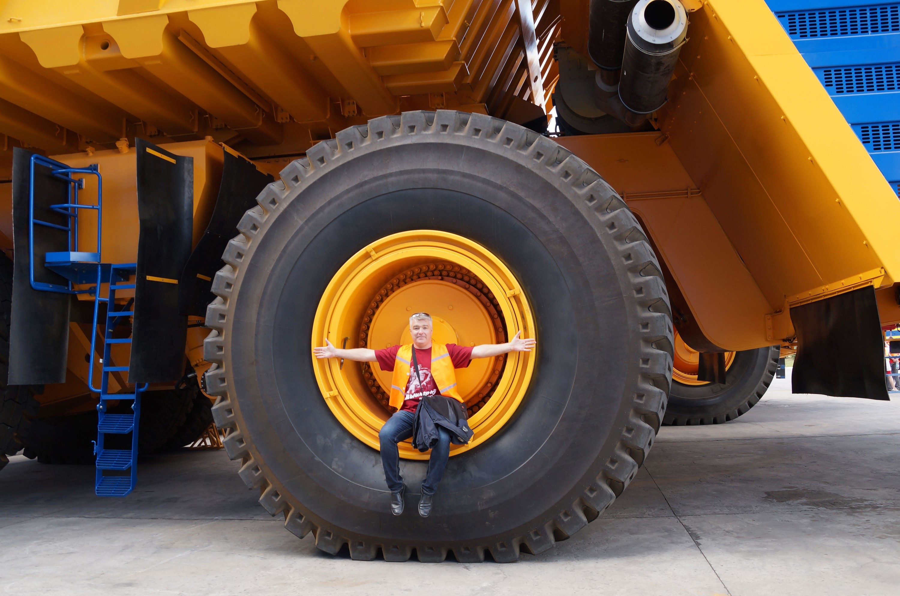 A person sitting on a truck wheel