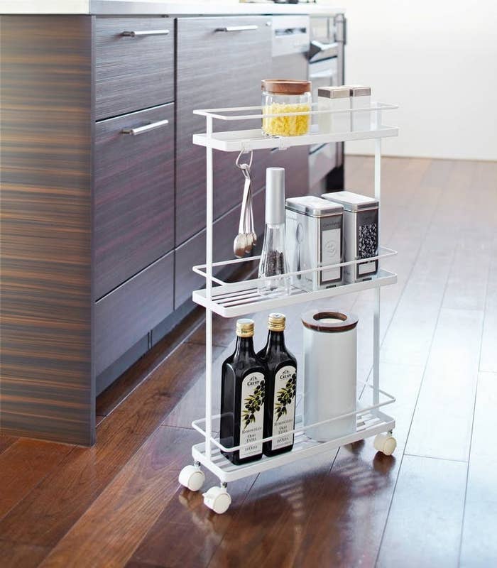 white three-tiered metal rolling cart