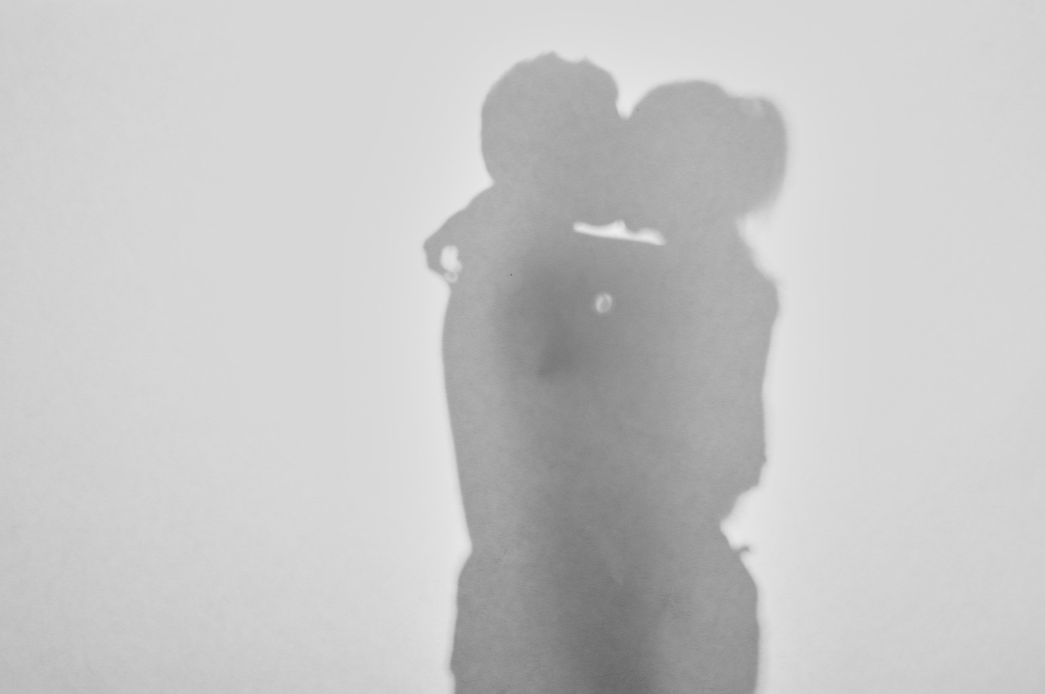 Silhouette of a couple embracing and kissing