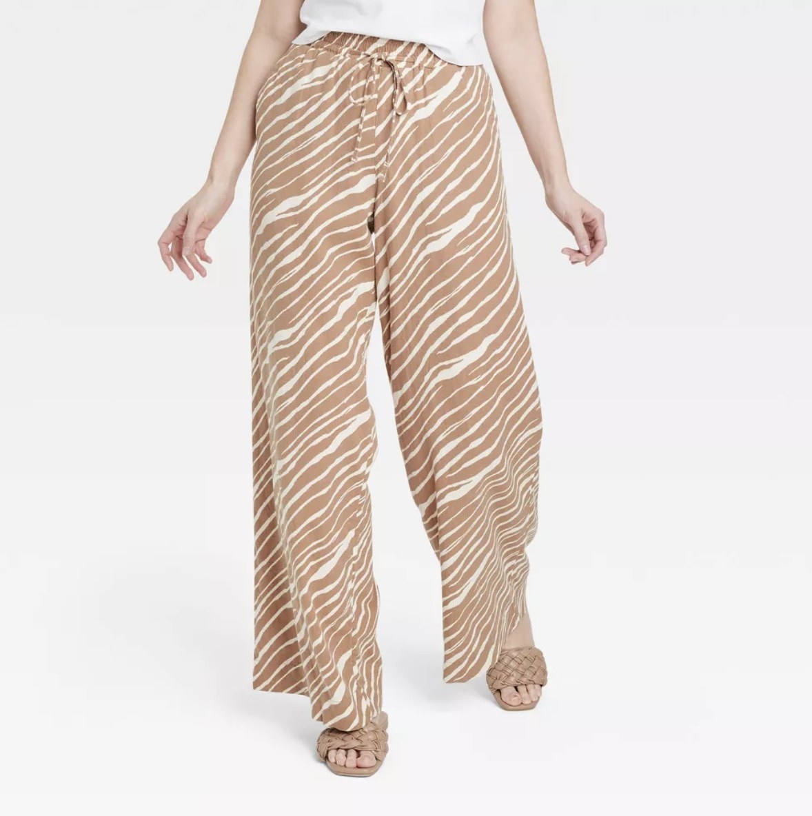 A pair of tan zebra print wide leg pants