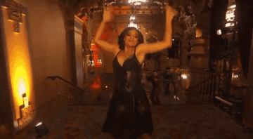 Ariana Debose jumping from stairs and being caught during dance number