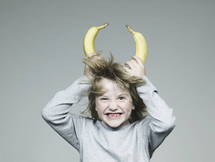 kid with bananas as horns on his head