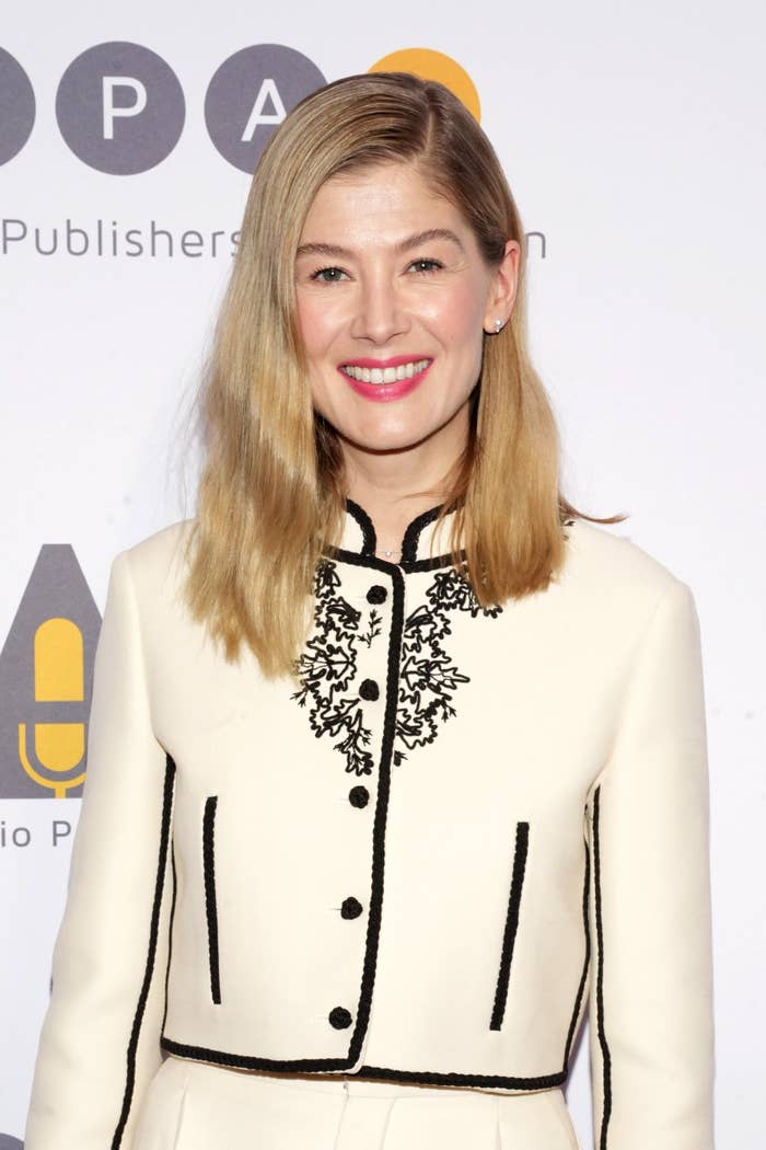 Close-up of Rosamund smiling and wearing a suit with cropped jacket