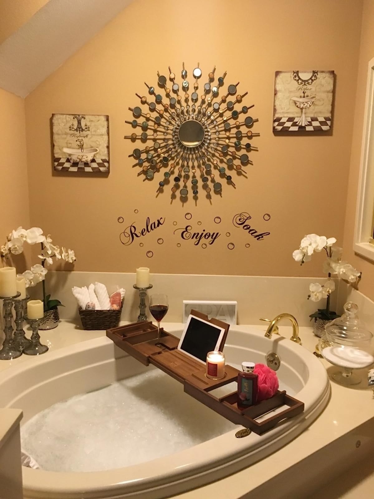 the bath caddy with an iPad, glass of wine, and lit candle above a jetted tub