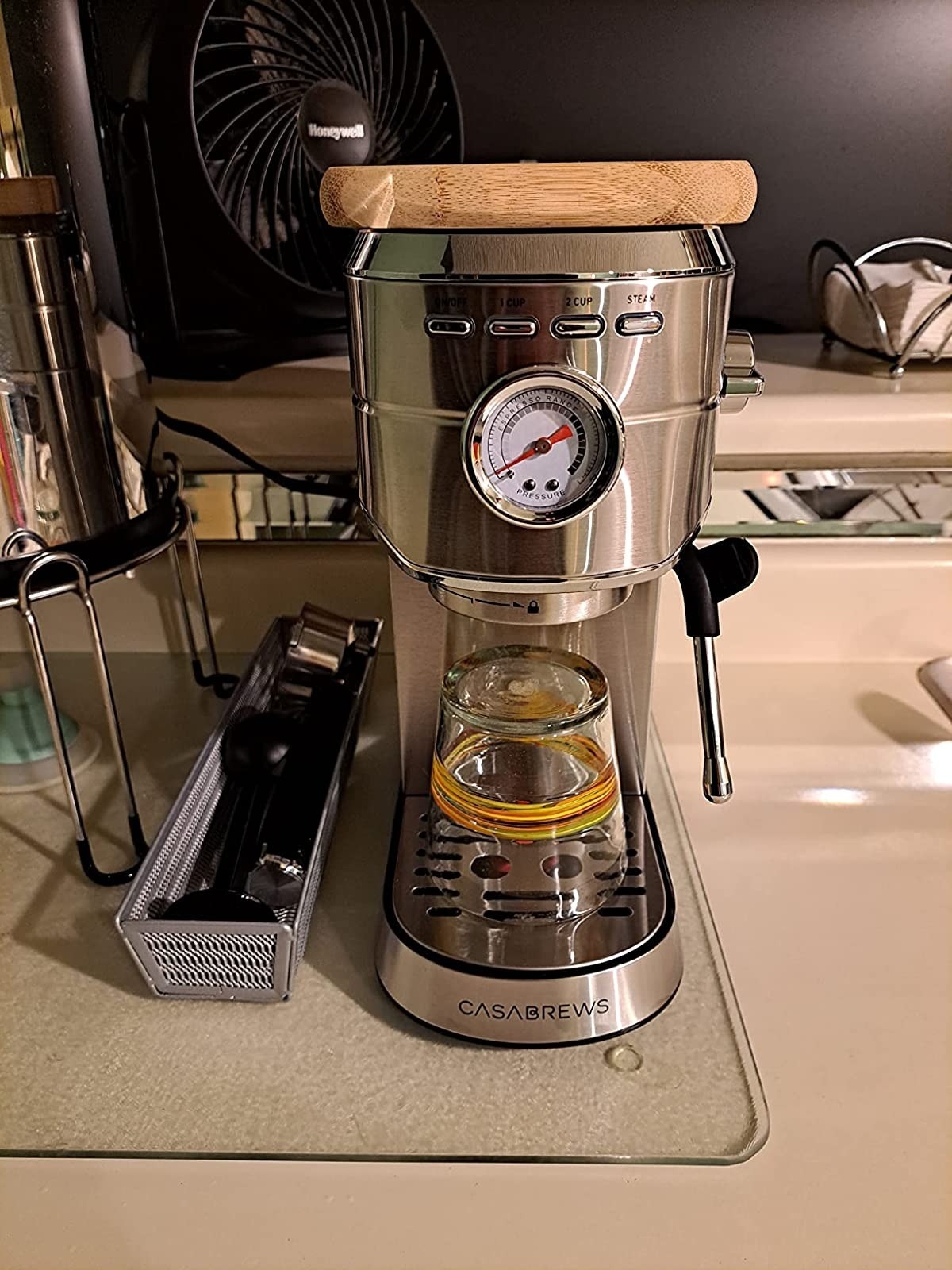 silver espresso machine with glass cup in brewing area