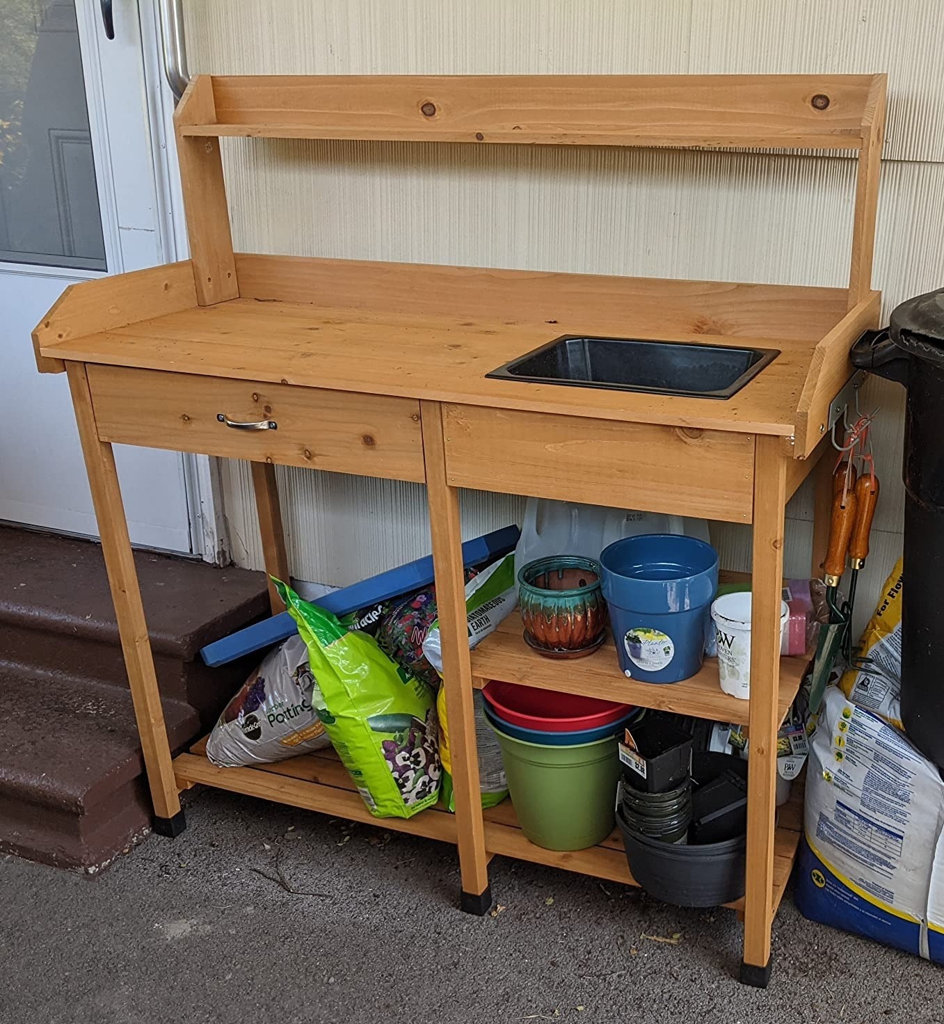 wood potting bench with shelves and storage areas for gardening supplies