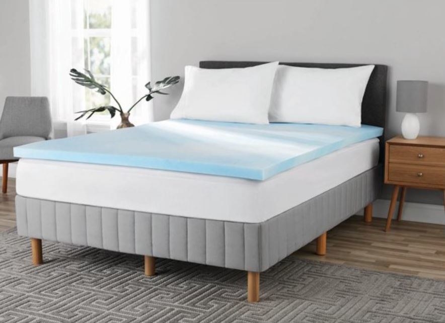 light blue mattress topper, mattress and bedframe in bedroom