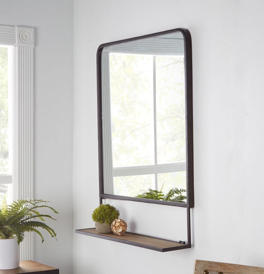 black metal rectangular wall mirror with a small shelf