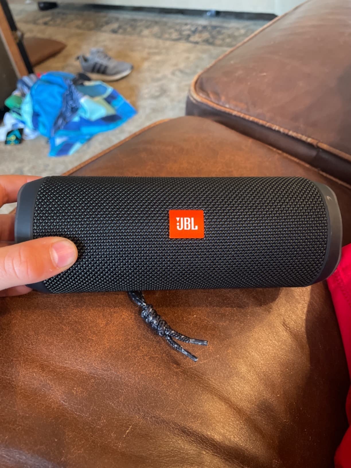 The JBL speaker on a couch