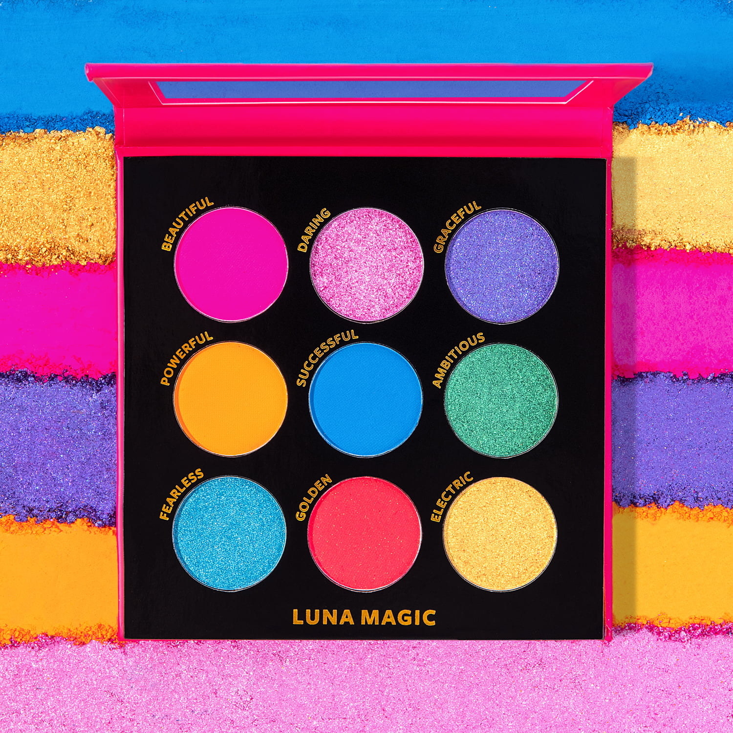 A photo of the colorful palette with the eyeshadow colors smeared behind it