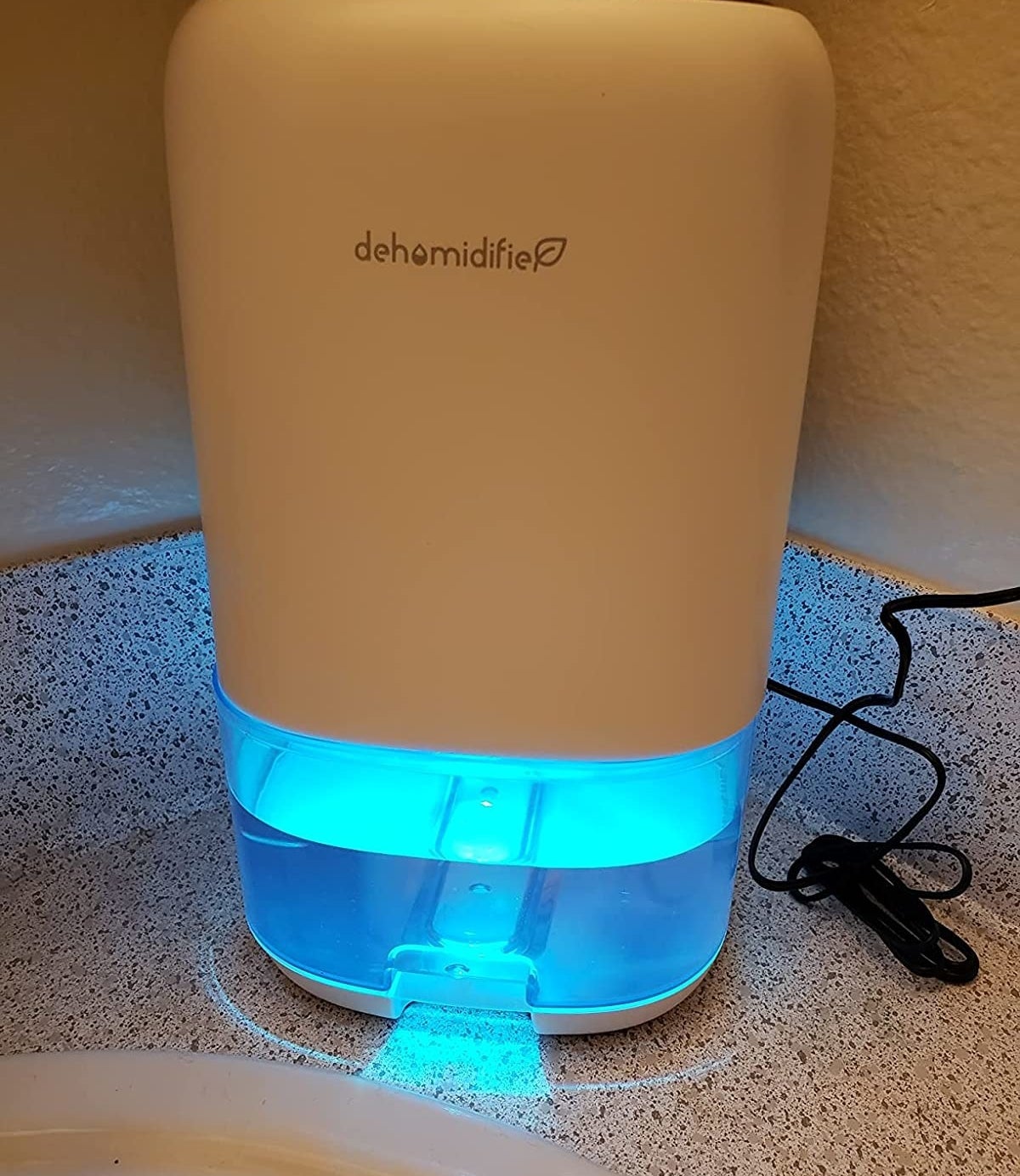 Reviewer&#x27;s dehumidifier sitting on bathroom counter