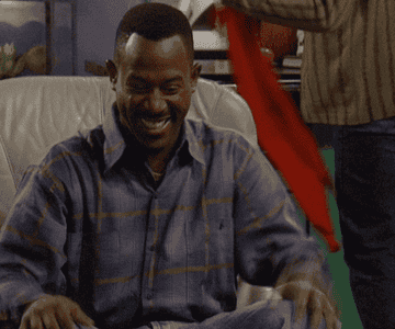 Martin Lawrence laughing and holding his belly