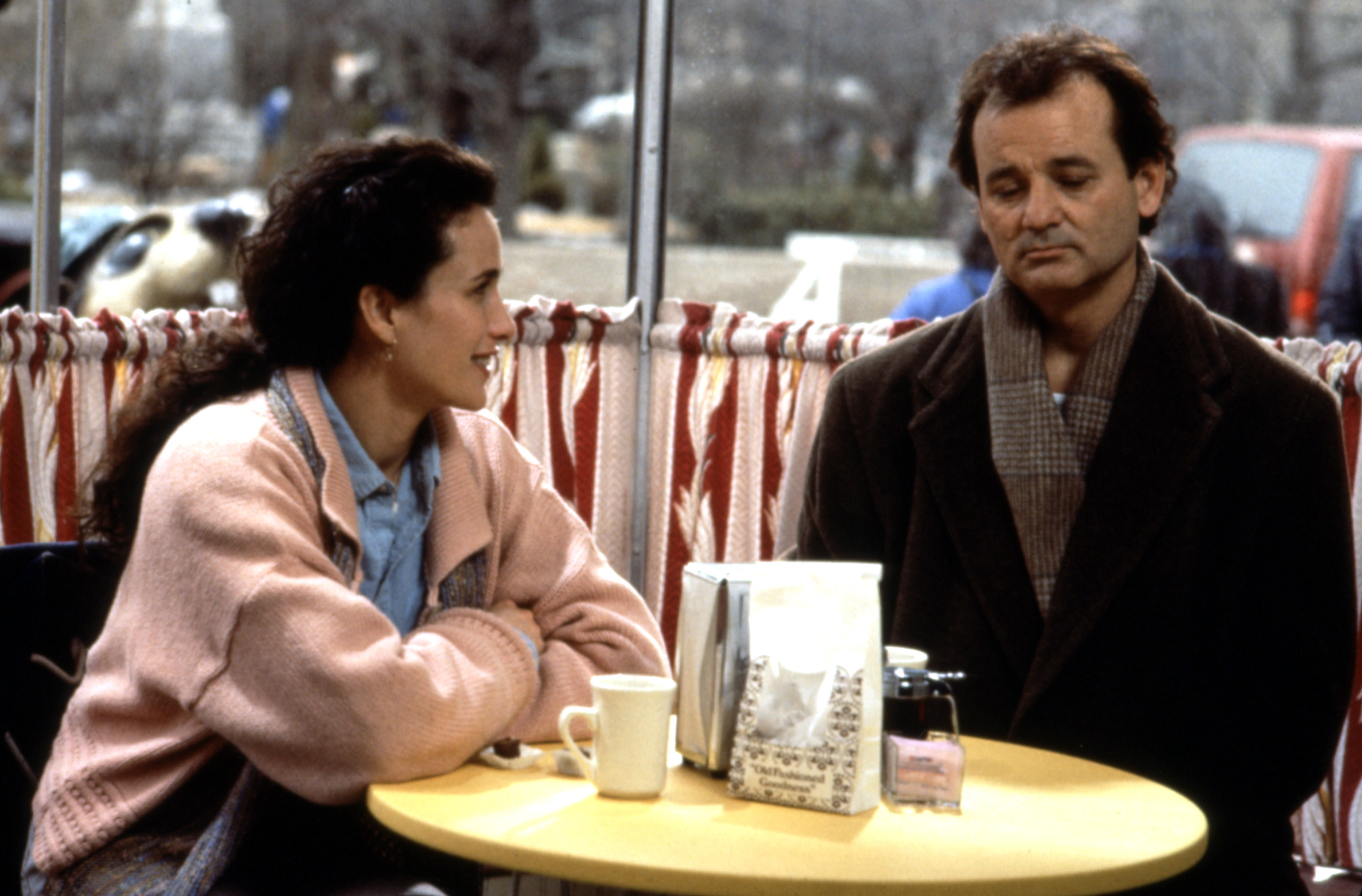 Andie MacDowell and Bill Murray sitting at a table in Groundhog Day