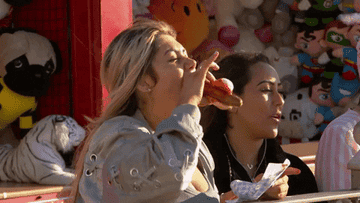 woman takes one bite of a hot dog and the weiner falls out of the bun