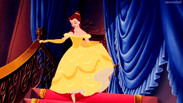 a gif of belle from beauty and the beast descending the stairs in her ballgown