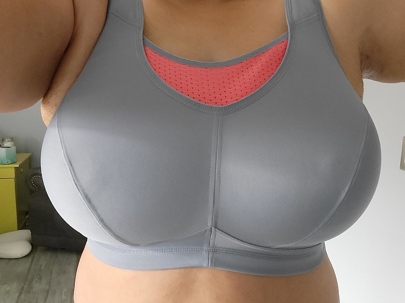 A reviewer in a grey and orange bra