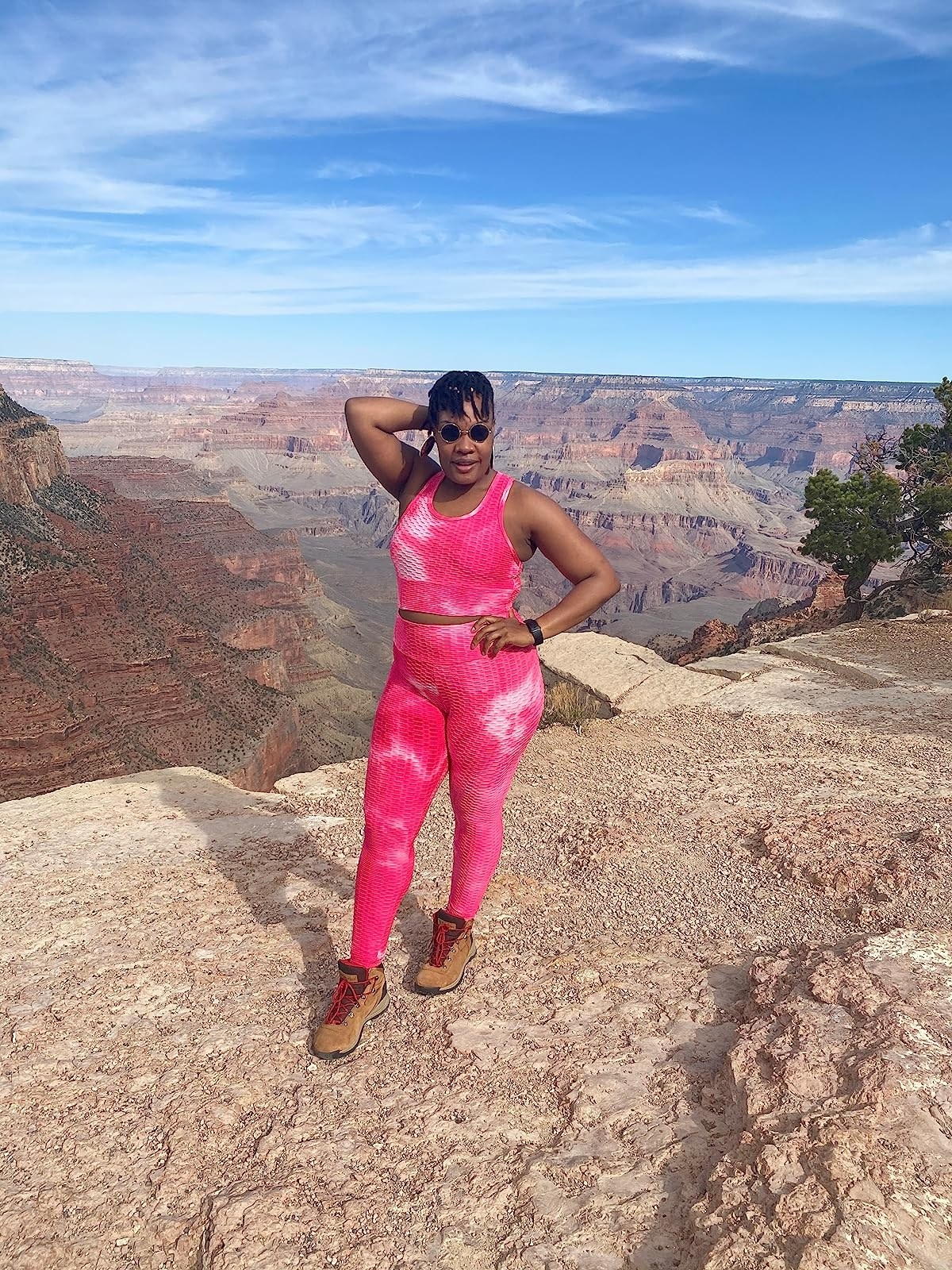 a reviewer wearing a pink matching set with brown hiking boots