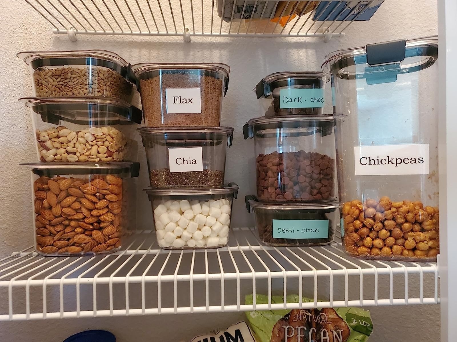 different-sized plastic containers from the food storage set with flax, chia, nuts, and other pantry staples
