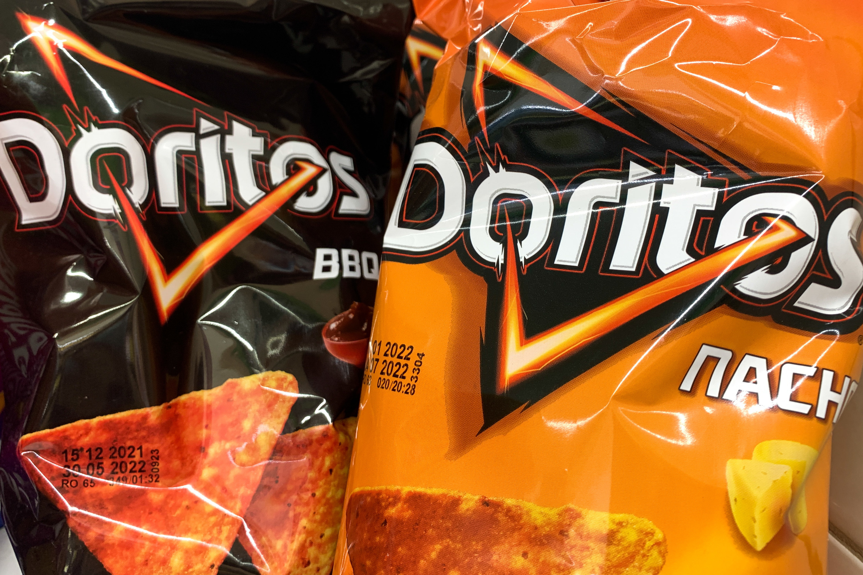 Two bags of Doritos flavors: BBQ and Nacho