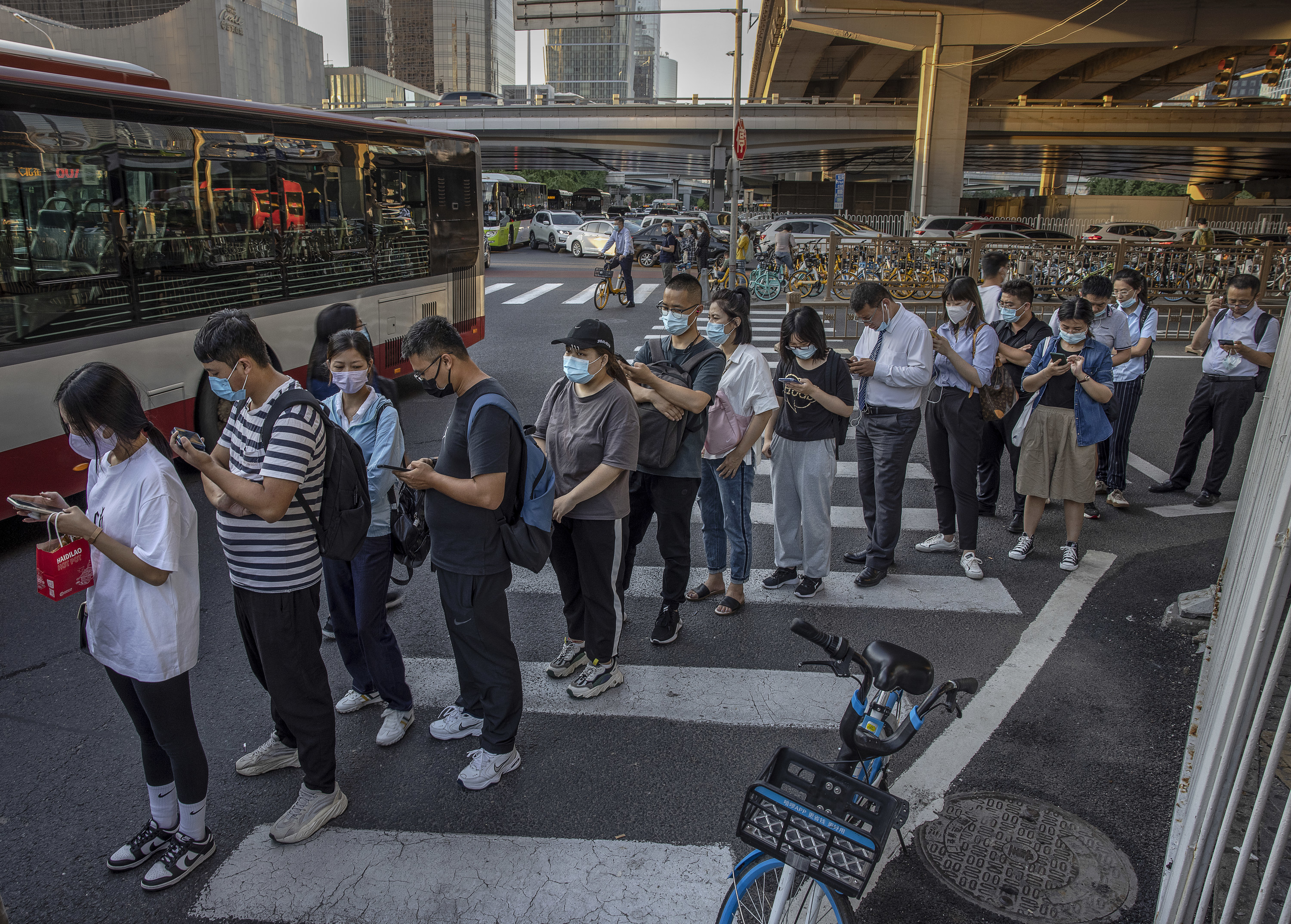chinese commuters waiting in line for the bus after work