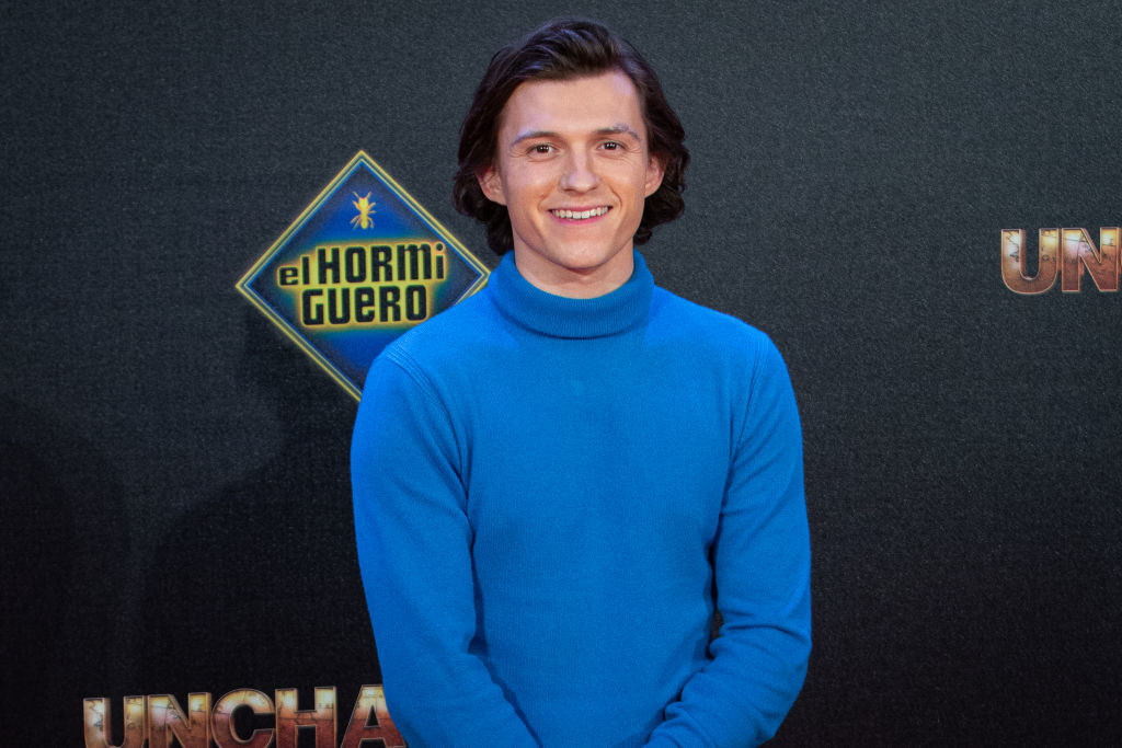 Close-up of Tom smiling and wearing a mock turtleneck sweater