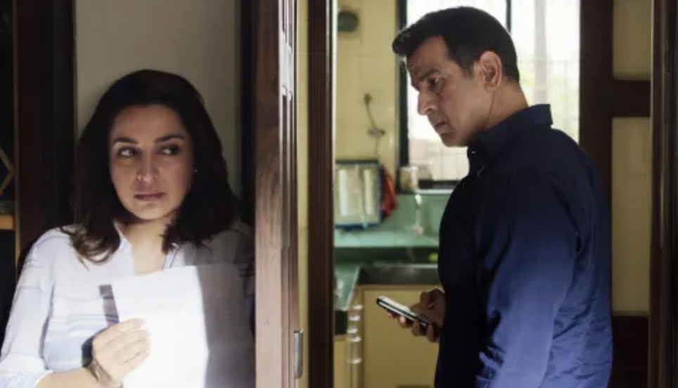 Tisca chopra hides behind a door while Ronit roy looks