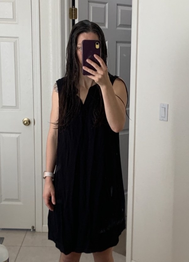 A reviewer wearing a black dress