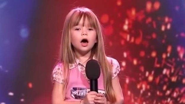 A young girl holding a microphone