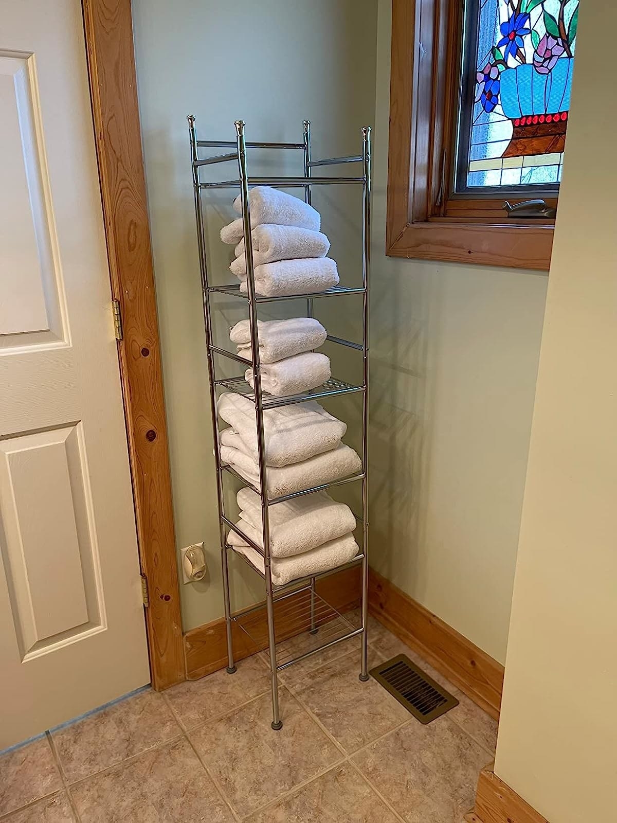Reviewer image of white folded towels on the shelf in their bathroom