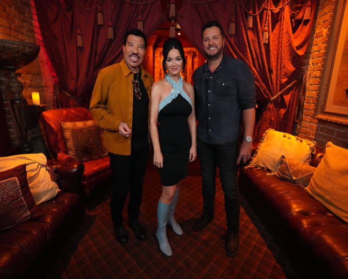 Lionel Richie, Katy Perry, and Luke Bryan smile for a photo together in a lounge