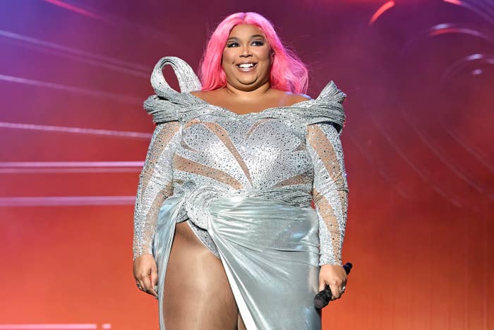 A closeup of Lizzo onstage in a sparkly gown