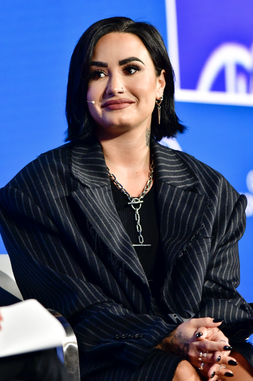 Demi sitting on stage during an interview