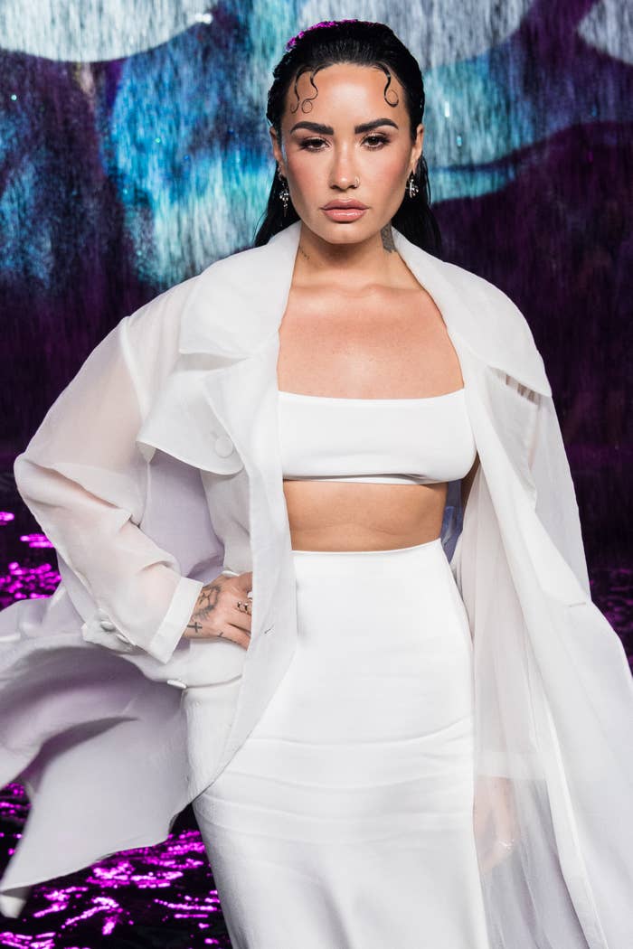 Demi rocking a bandeau top with a matching skirt and sheer duster