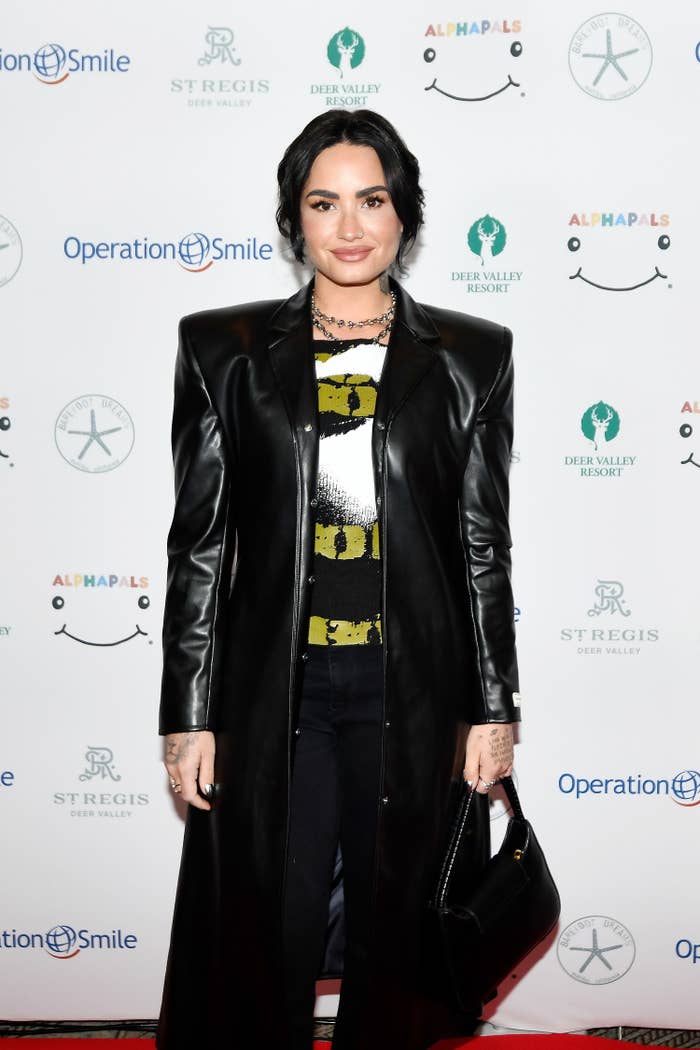 Demi smiles for photographers at a red carpet event