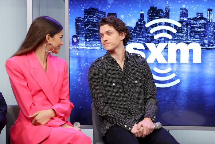 Zendaya and Tom look at each other during an interview
