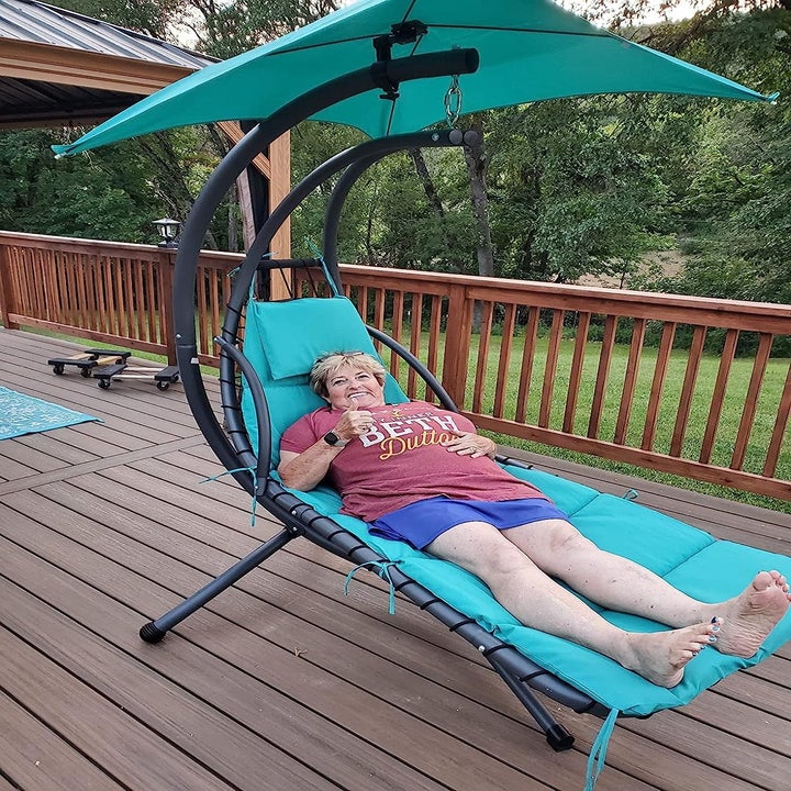 a reviewer lay on their teal chaise lounge