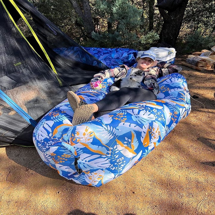 reviewer laying in blue patterned inflated lounger