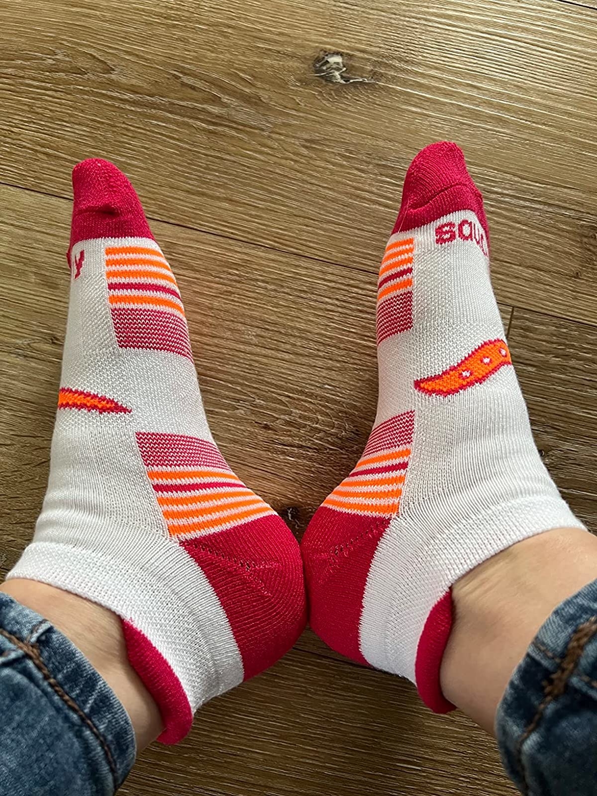 a reviewer wearing white, red and orange socks