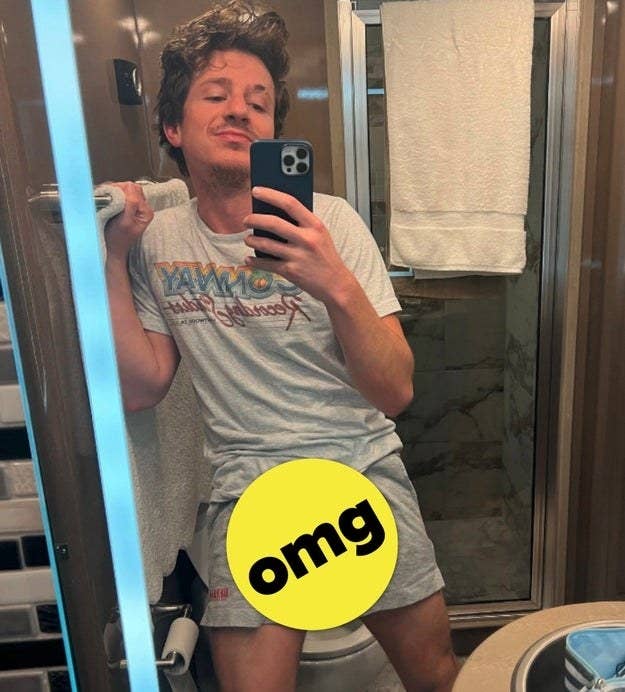 Charlie taking a selfie while wearing shorts and a T-shirt with an &quot;omg&quot; sticker covering his crotch area