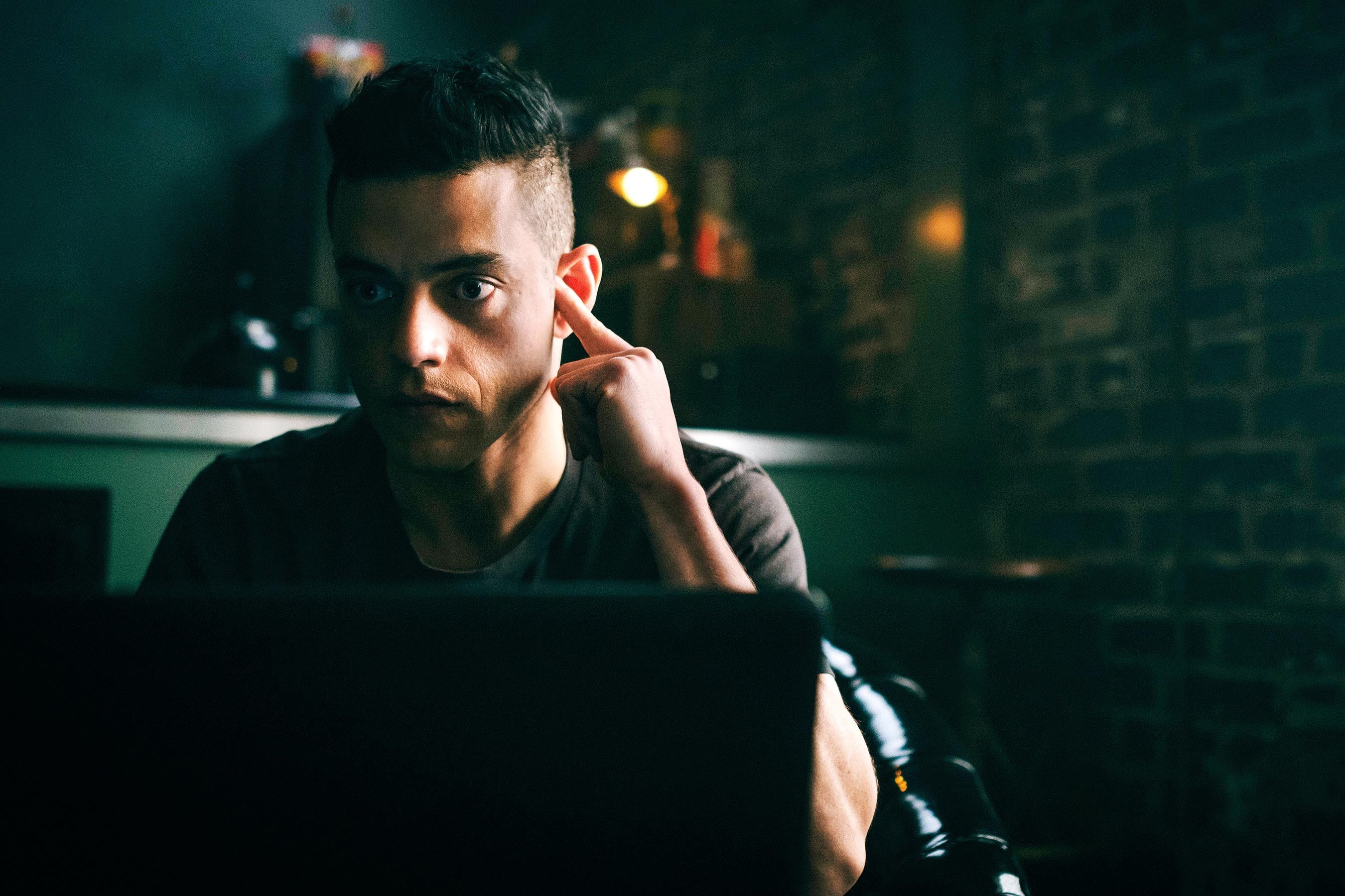 closeup of him behind a laptop